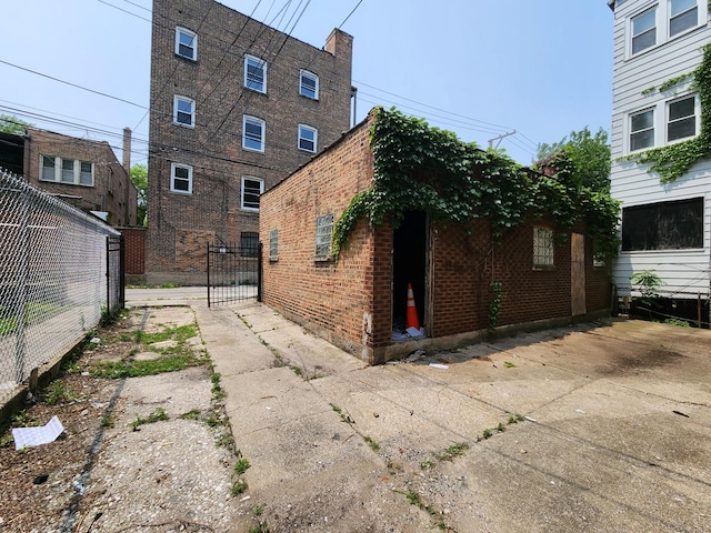 7952 S Langley Ave, Chicago, IL 60619 - view of home's exterior with brick siding and a gate