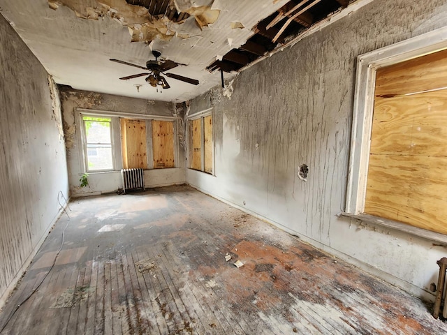 7952 S Langley Ave, Chicago, IL 60619 - spare room with radiator heating unit, ceiling fan, and hardwood / wood-style floors