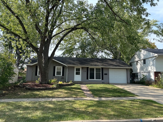 view of front of property with a garage and a front lawn