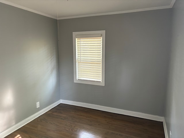 spare room featuring crown molding and dark wood-type flooring