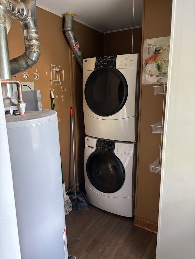 laundry room featuring dark hardwood / wood-style floors and stacked washing maching and dryer