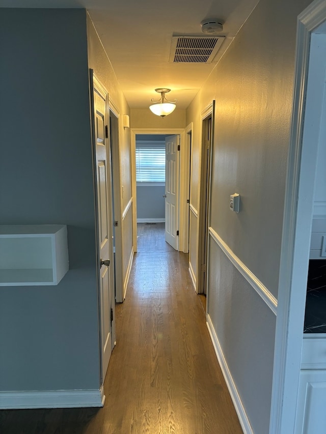 corridor with wood-type flooring