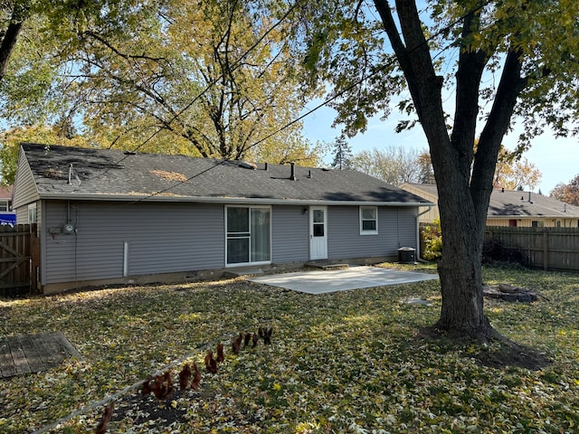 back of house with a lawn, central AC unit, and a patio area