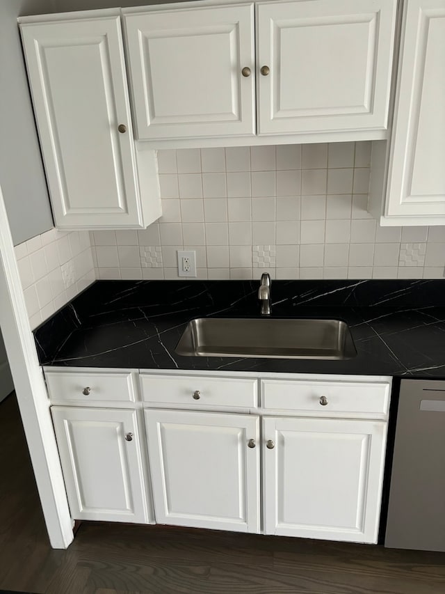 kitchen featuring decorative backsplash, dark wood-type flooring, sink, dishwasher, and white cabinetry