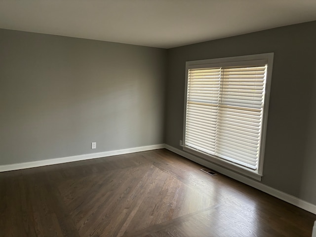 empty room with dark wood-type flooring