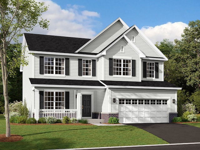 view of front of home with a front yard and a garage