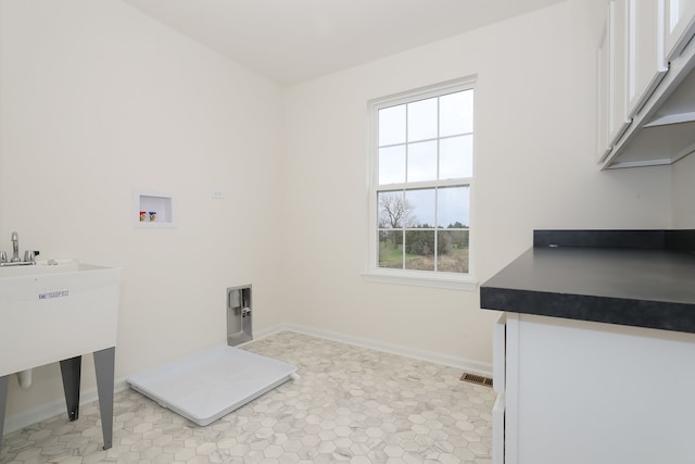 washroom featuring hookup for a washing machine, light tile patterned floors, cabinets, and hookup for an electric dryer