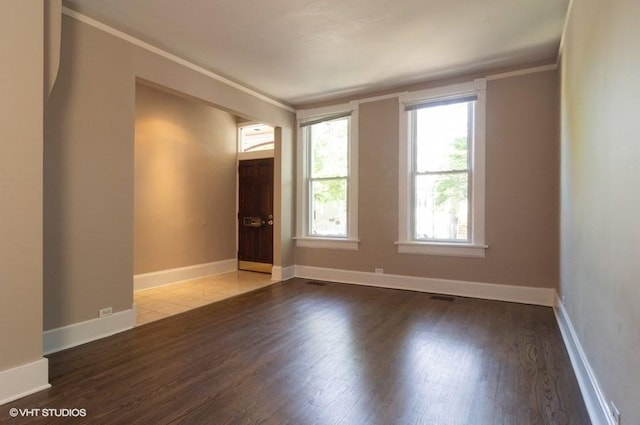 unfurnished room featuring crown molding and wood-type flooring