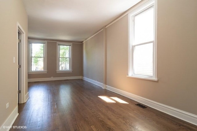 spare room with dark hardwood / wood-style floors