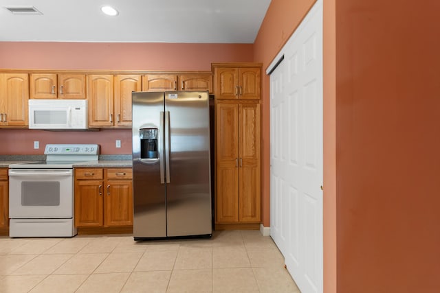 kitchen featuring recessed lighting, white appliances, light tile patterned flooring, visible vents, and brown cabinets
