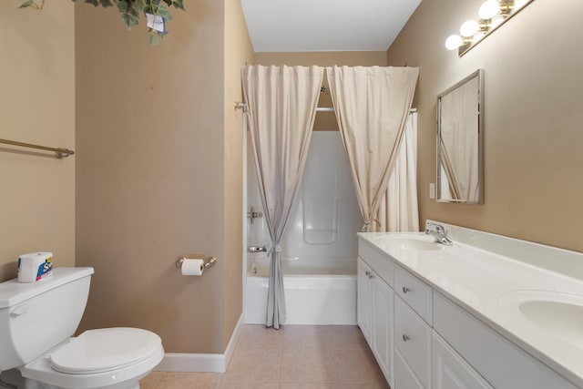 full bathroom with toilet, a sink, tile patterned floors, double vanity, and baseboards