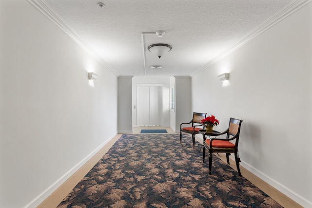corridor with baseboards, a textured ceiling, and crown molding