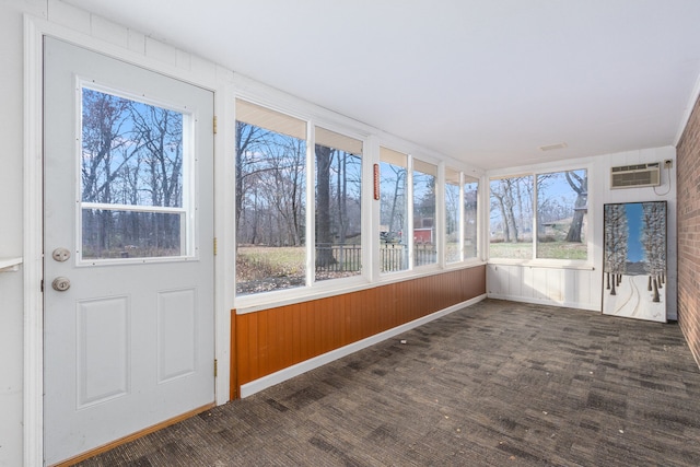 unfurnished sunroom with a wealth of natural light and a wall mounted AC