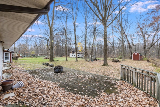 view of yard with a fire pit and a storage shed