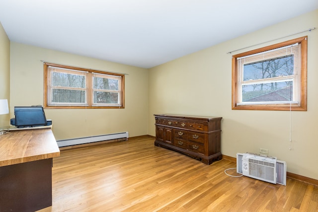 office area with light hardwood / wood-style flooring and a baseboard radiator