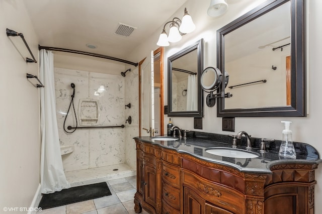 bathroom featuring tile patterned floors, vanity, and walk in shower