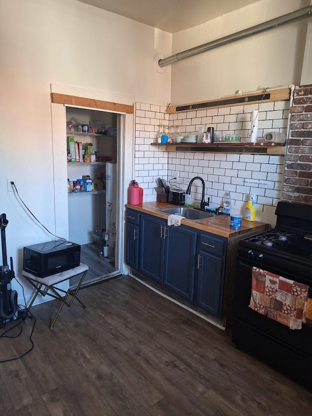 kitchen with blue cabinetry, electric range, sink, dark wood-type flooring, and wood counters