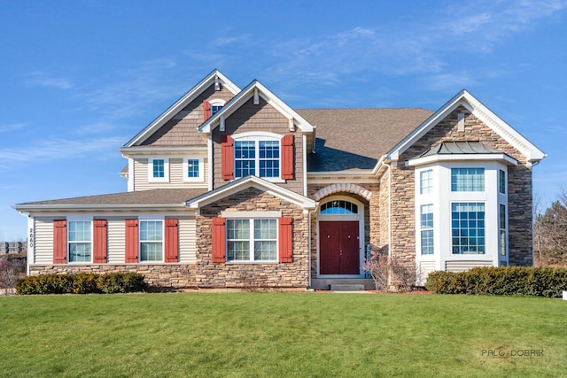 view of front of home with a front lawn and stone siding