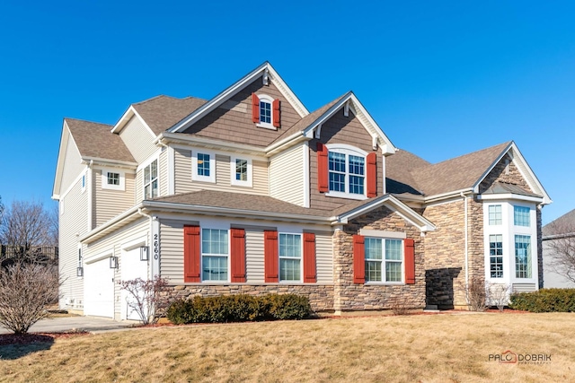 view of front facade with a garage and a front lawn