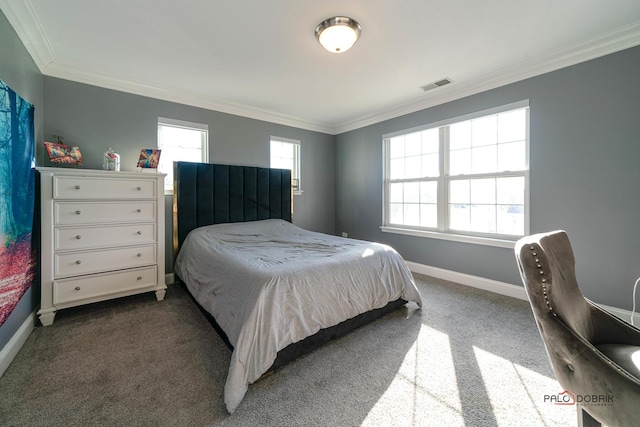 bedroom with dark colored carpet, visible vents, baseboards, and ornamental molding