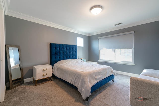 carpeted bedroom featuring baseboards, visible vents, and ornamental molding