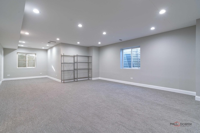 carpeted spare room featuring recessed lighting and baseboards