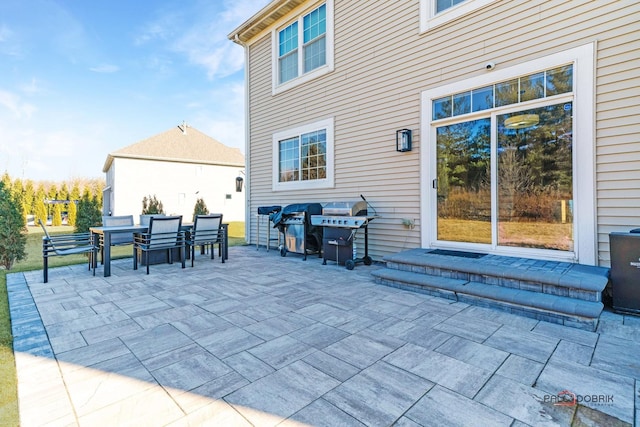 view of patio with outdoor dining area and grilling area