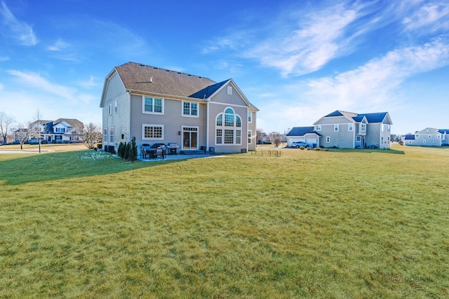 rear view of house featuring a lawn