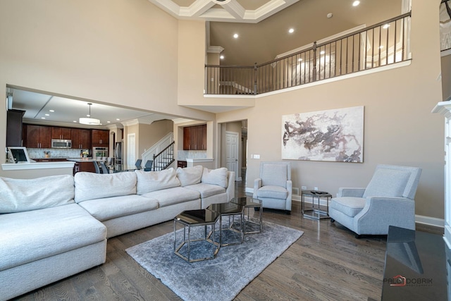 living room with dark wood-style floors, stairs, and ornamental molding