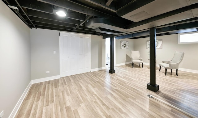 basement with hardwood / wood-style flooring