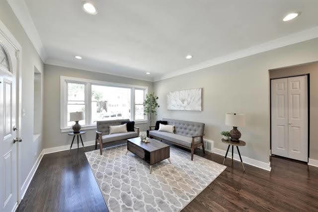 living room featuring crown molding and dark hardwood / wood-style floors