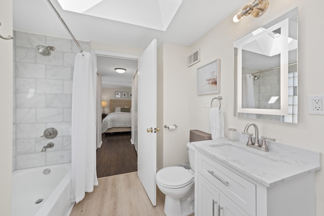 full bathroom with shower / bath combo with shower curtain, hardwood / wood-style floors, vanity, and toilet