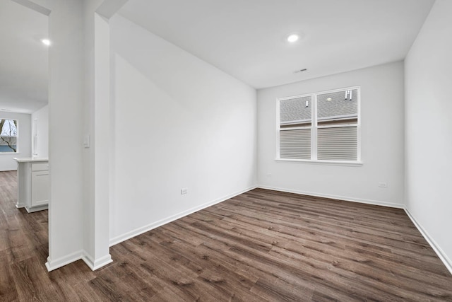 spare room with dark hardwood / wood-style flooring