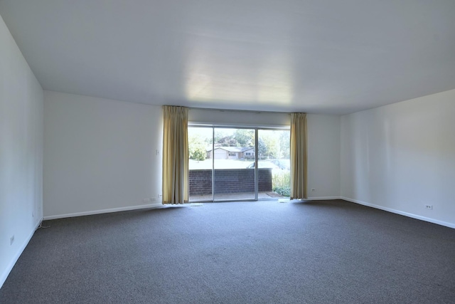 empty room featuring dark colored carpet