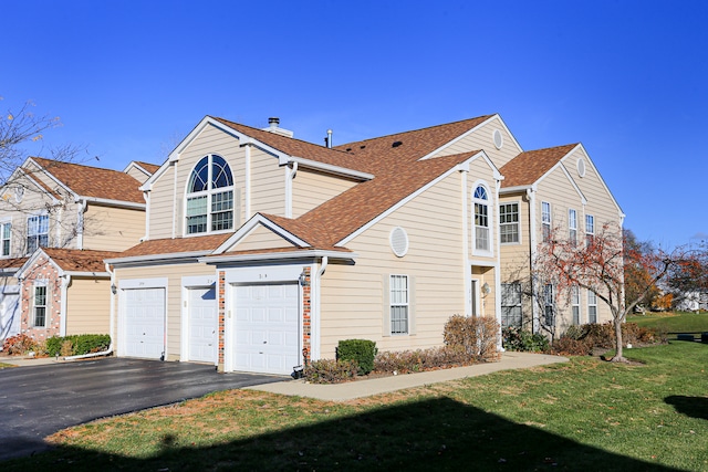 view of front of home with a front lawn and a garage