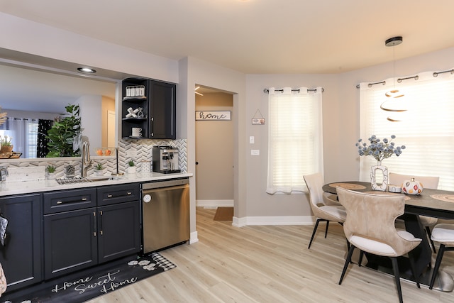 kitchen with dishwasher, sink, light hardwood / wood-style floors, pendant lighting, and decorative backsplash