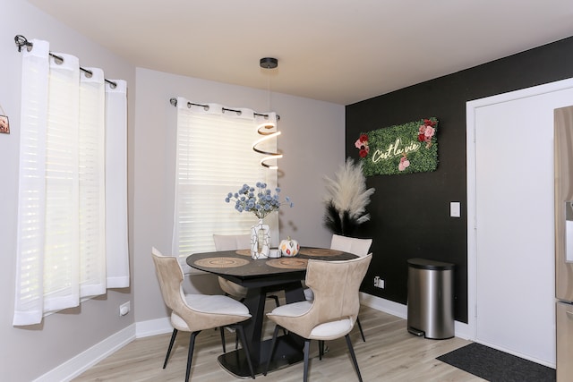 dining area with light hardwood / wood-style floors