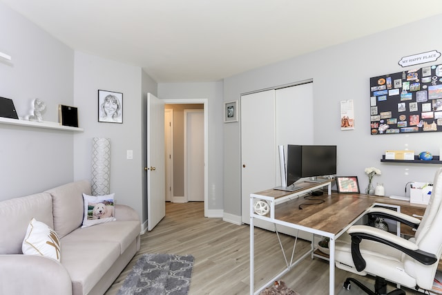 home office with light hardwood / wood-style floors