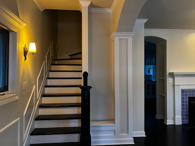 staircase featuring ornamental molding