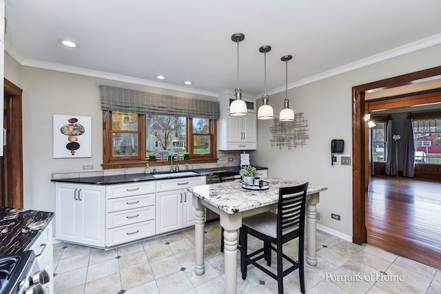 kitchen with crown molding, sink, dark stone counters, and stainless steel range oven