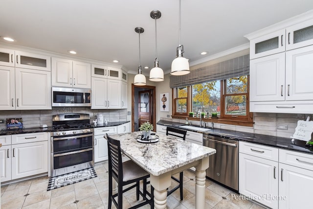 kitchen featuring backsplash, white cabinets, and stainless steel appliances