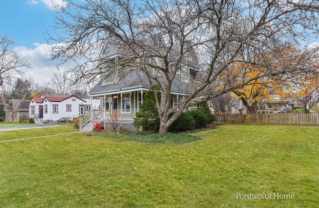 exterior space with covered porch and a front yard