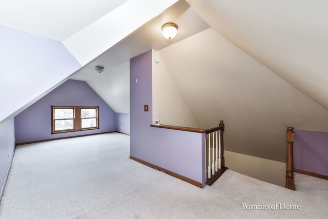 additional living space featuring lofted ceiling and light carpet