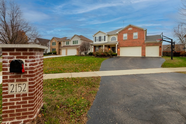 front of property with a front yard and a garage