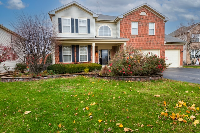 front of property featuring a front lawn and a garage