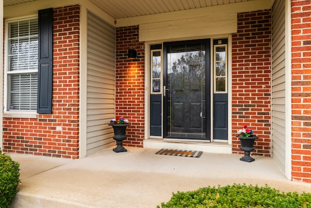 view of exterior entry featuring a porch