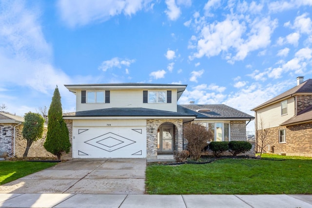 view of property featuring a front lawn and a garage