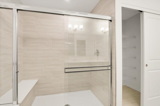 bathroom with toilet, vanity, tile patterned floors, and a shower with door