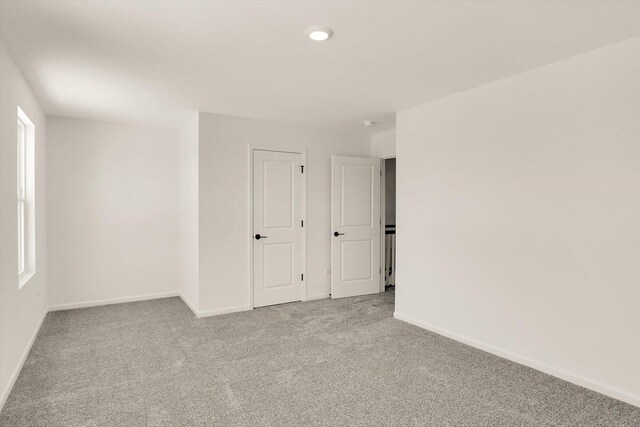 carpeted bedroom with a notable chandelier