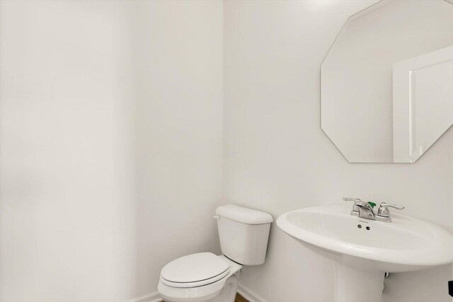 washroom with washer and dryer, dark hardwood / wood-style floors, cabinets, and sink